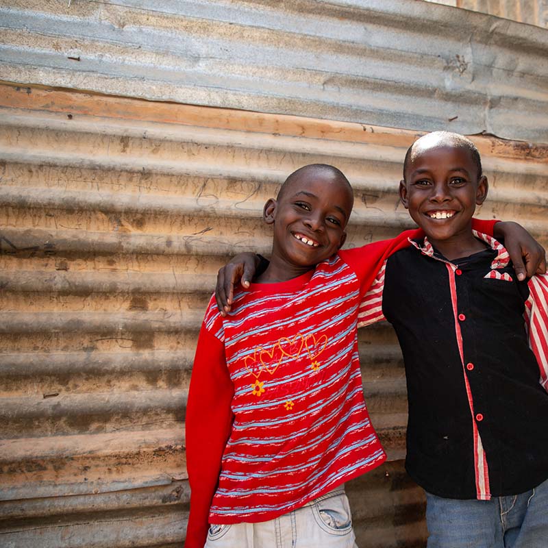 In Somalia, two brothers smile while putting their arms around one another. 