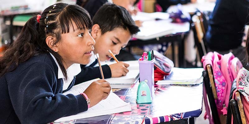 Mexico, a girl does schoolwork in a classroom