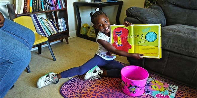 A student reads a book at her South Carolina home