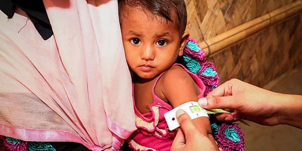 Baby Laila*, 22 months old, is measured with a MUAC band in a Save the Children Health Assessment Centre in Leda Camp, Cox’s Bazar, Bangladesh.