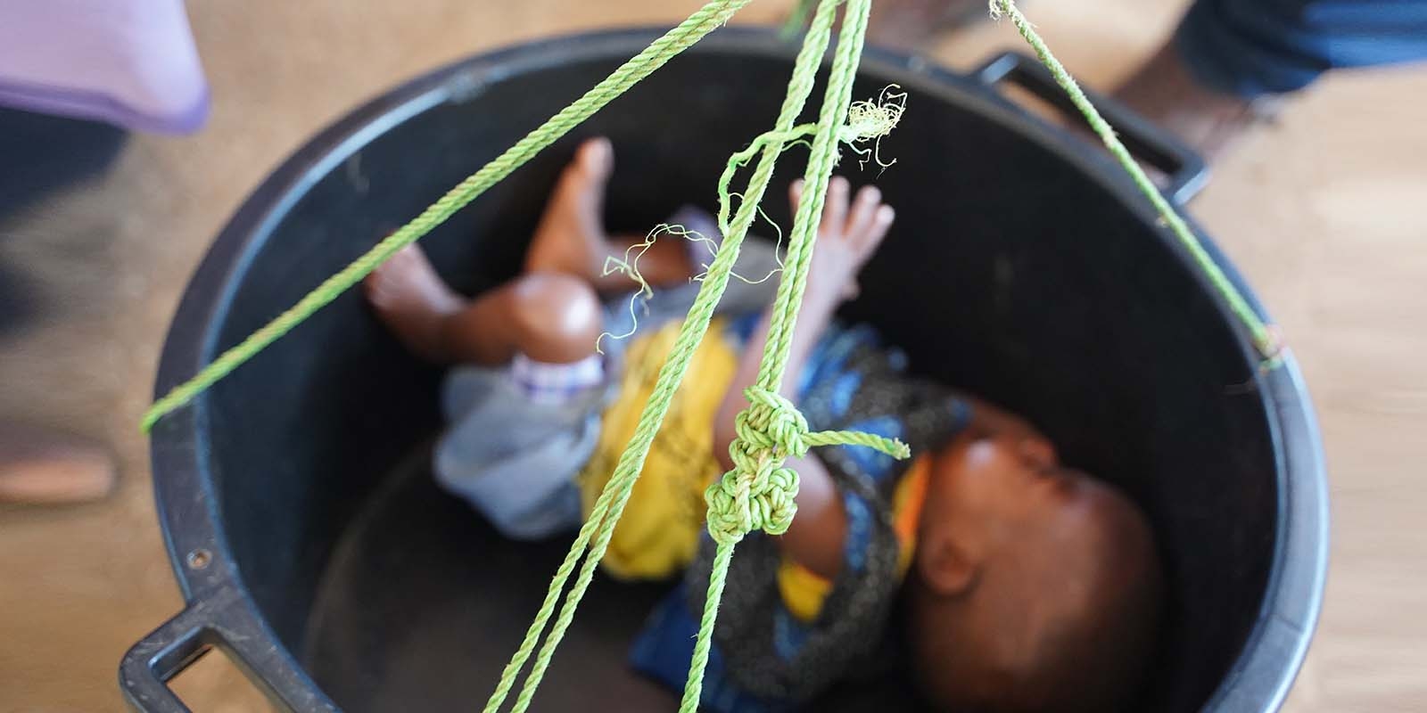 In Somalia, a baby is weighed and screened for malnutrition. 