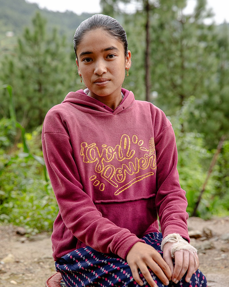 A teenage girl in Nepal sits for a portrait