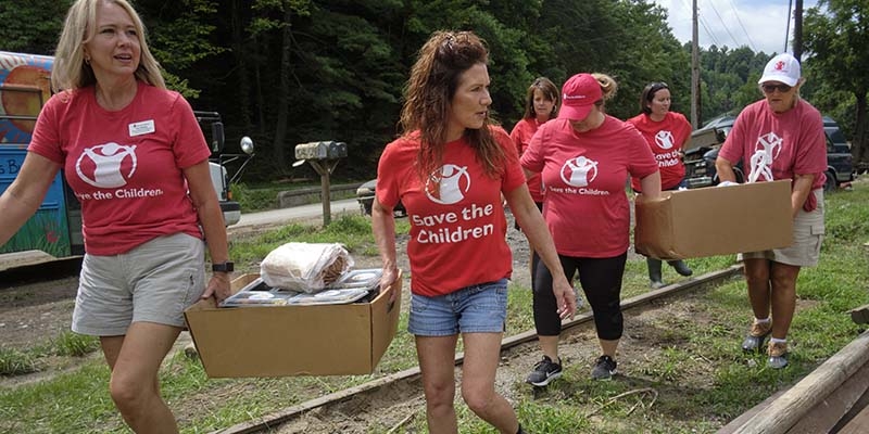 Save the Children staffers carry supplies to families impacted by the Kentucky Floods. 
