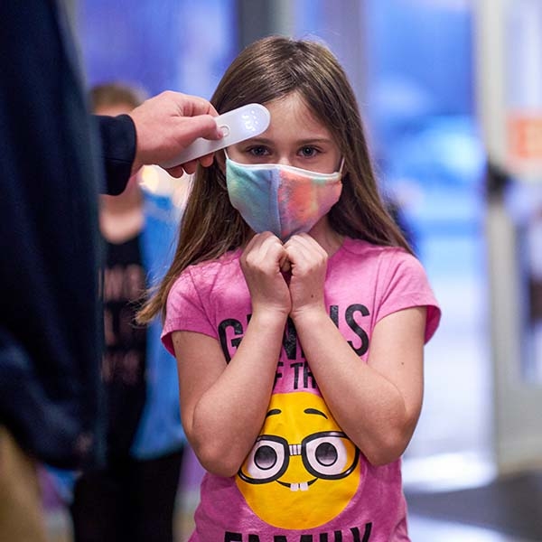 A student gets her forehead temperature checked in the hallway of a school in Tennessee.