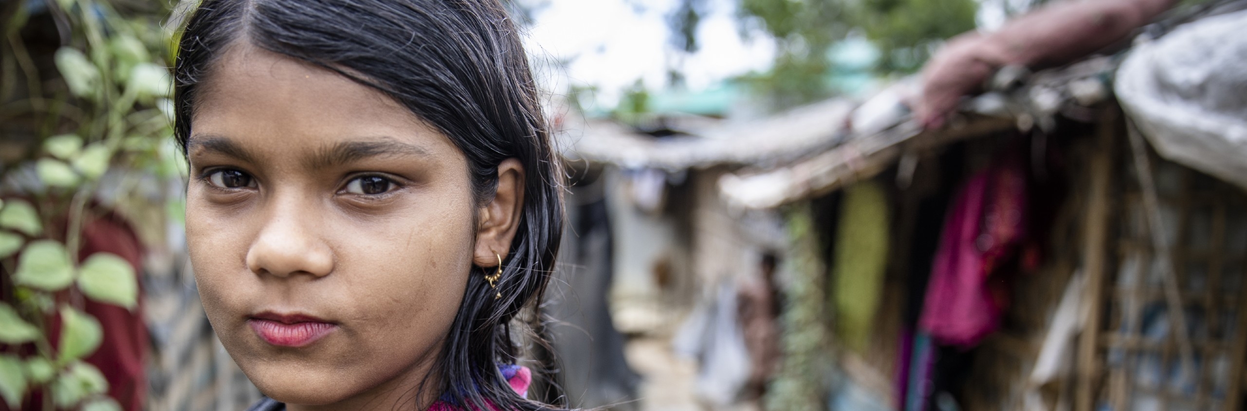 Marium*, 11, stands near her home in a camp for Rohingya Refugees in Cox’s Bazar, Bangladesh.