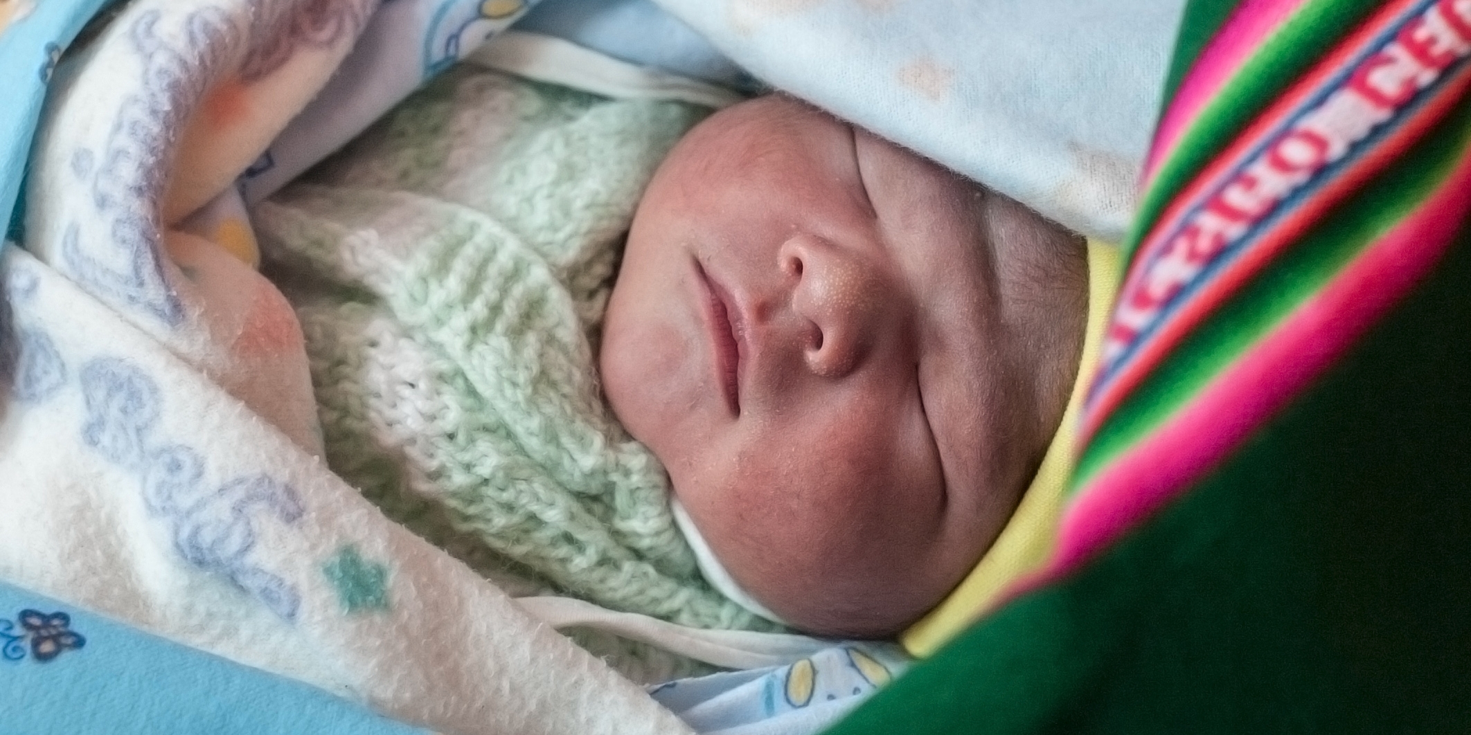 A healthy newborn, a brand new, one-day-old baby, here in his colorful aguayo, and his mother Liseth are alive and thriving, thanks to the support of Save the Children's vital work in Bolivia. Photo Credit: Susan Warner/Save the Children 2015.