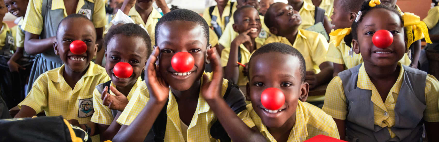 Smiling second-grade students in Haiti put red noses on to celebrate Red Nose Day. This fun fundraising campaign brings people together to raise money and change the lives of kids who need our help the most. We reached more than 15,000 girls and boys in need in urban Port-au-Prince, Haiti, working with teachers, parents and community leaders to improve the quality of education the children receive. Photo credit: Susan Warner/Save the Children, February 2016. 