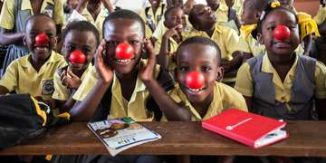 Smiling second-grade students in Haiti put red noses on to celebrate Red Nose Day. This fun fundraising campaign brings people together to raise money and change the lives of kids who need our help the most. We reached more than 15,000 girls and boys in need in urban Port-au-Prince, Haiti, working with teachers, parents and community leaders to improve the quality of education the children receive. Photo credit: Susan Warner/Save the Children, February 2016. 