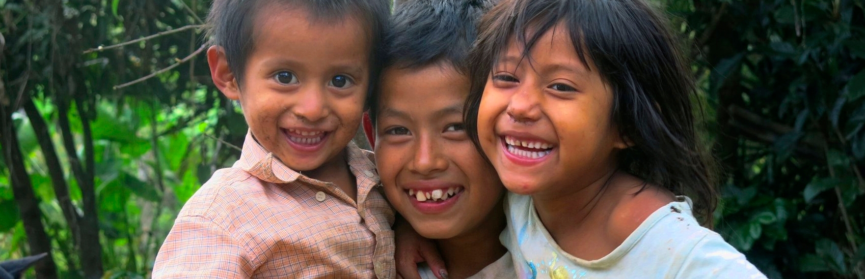 Kevin (age 11) with two of his seven siblings. The nine children are being raised by a single mother, their father left. Kevin is no longer at school as his mother can’t afford the costs. He helps his mother when he can, picking tomatoes or cutting coffee if they can find work due to the coffee rust – a blight that is killing coffee plants. The younger siblings are losing weight; the youngest has severe diarrhea due to poor hygiene and no sanitation. Save the Children Honduras is helping this family with bananas and other emergency food packages. Photo credit: Save the Children, June 2014.