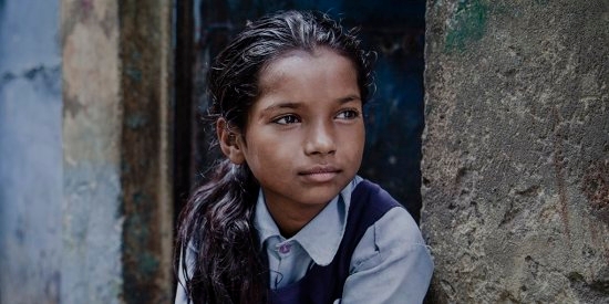 A girl of 9 lives with her mother, father and eight siblings in a small shanty in the slums positioned directly next to the railway tracks of New Delhi, India. She regularly attends a Save the Children learning center, and dreams of being a dancer when she grows up. Photo Credit: CJ Clarke/Save the Children 2014.