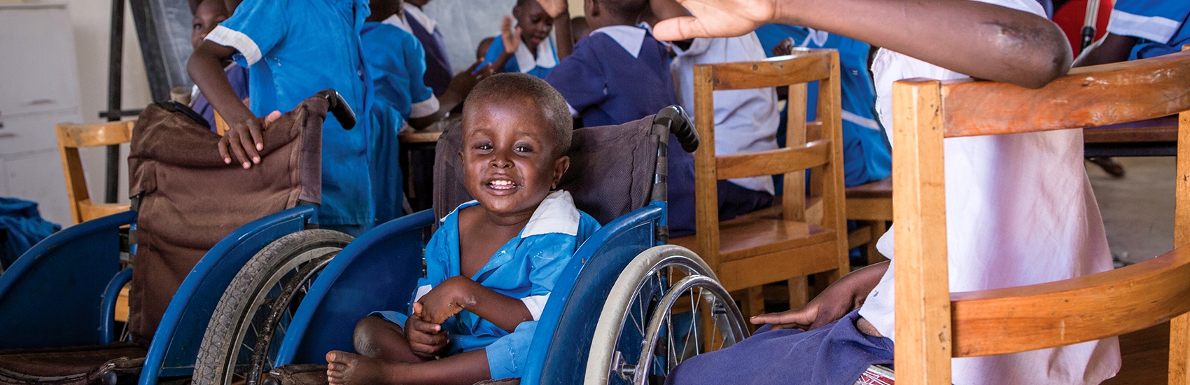 A young boy from Kenya sits in a wheelchair