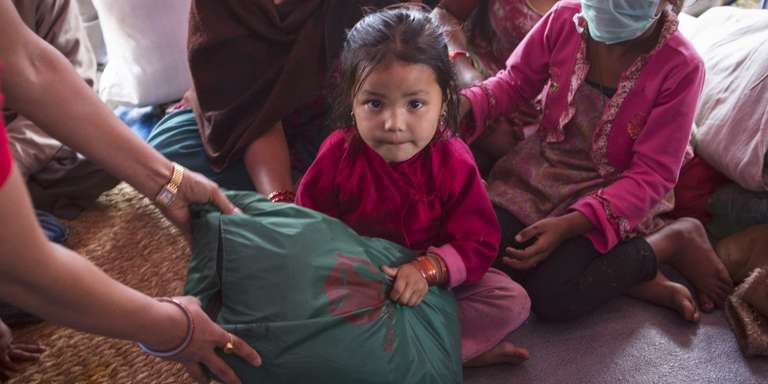 Aswini, age four, lived with her family in a tent settlement in Nepal after the earthquake. Save the Children provided displaced families, including Aswini’s, essential items including infant kits, warm clothes, hats and blankets as well as hygiene kits. Photo credit: Jonathan Hyams/Save the Children, April 2015.