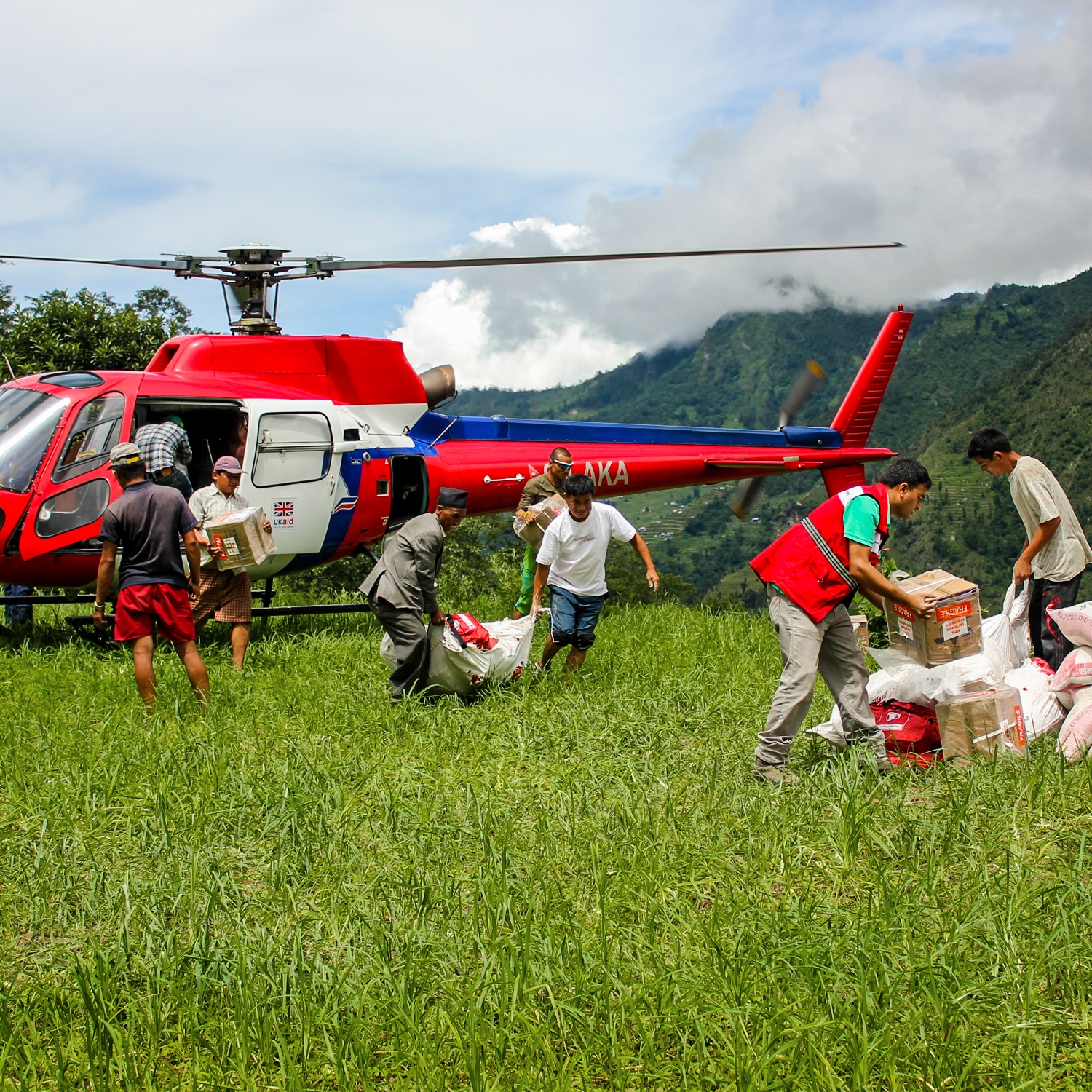 A helicopter lands to deliver health supplies in Nepal. 