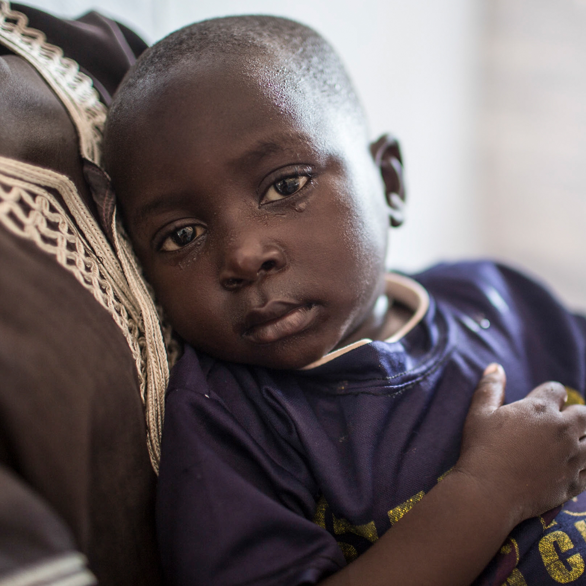 Tiny Joseph, in the arms of his mother, Viola. After fleeing South Sudan, Joseph had chest pain, a fever and was coughing. His mother brought him to a Save the Children Emergency Health Unit where he was treated with lifesaving antibiotics. Photo credit: Guilhem Alandry/Save the Children, March 2017. 