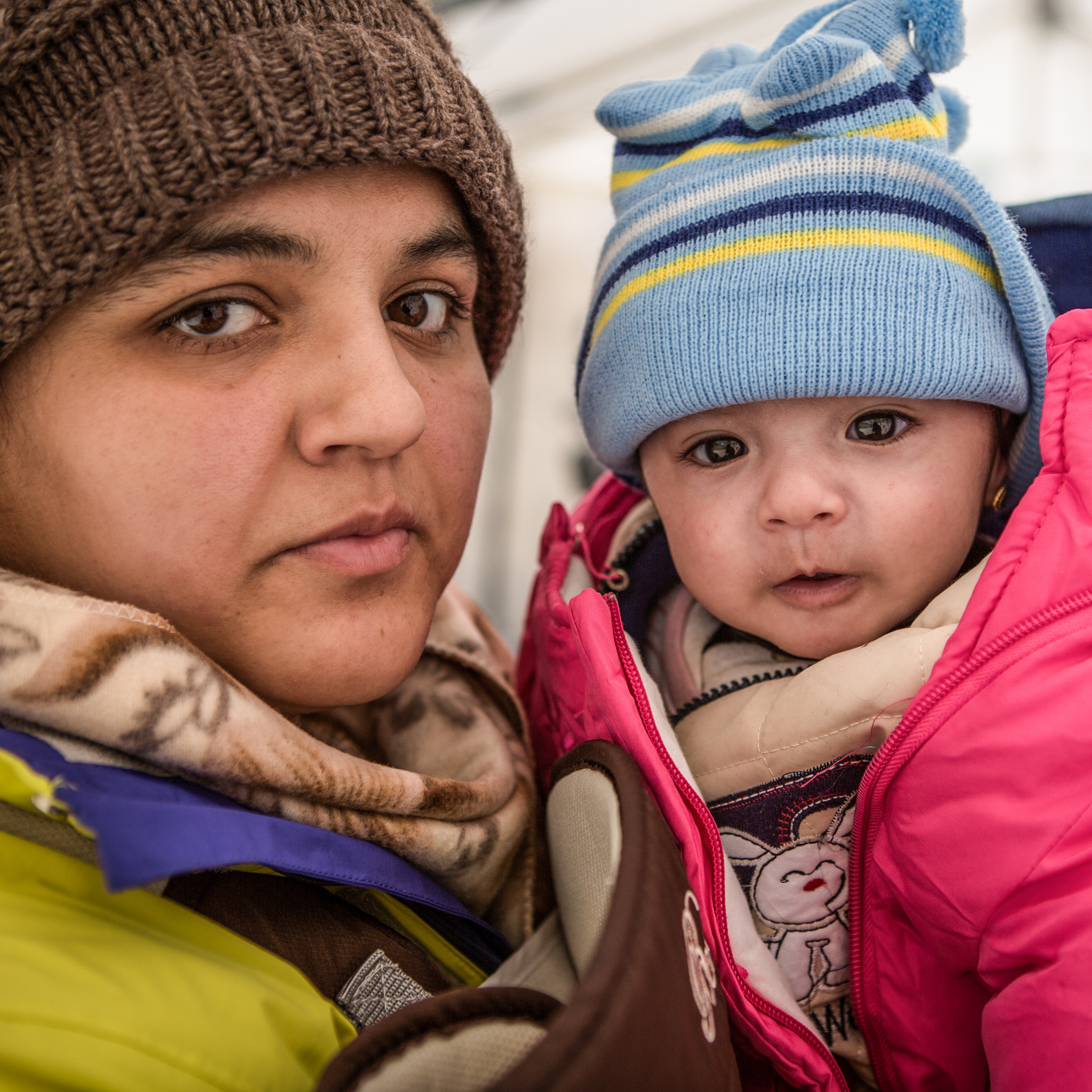 Rabia and her daughter Yasmin take shelter from the snow and freezing temperatures in a tent with their family. Photo credit: Jonathan Hyams/Save the Children, January 2016. 