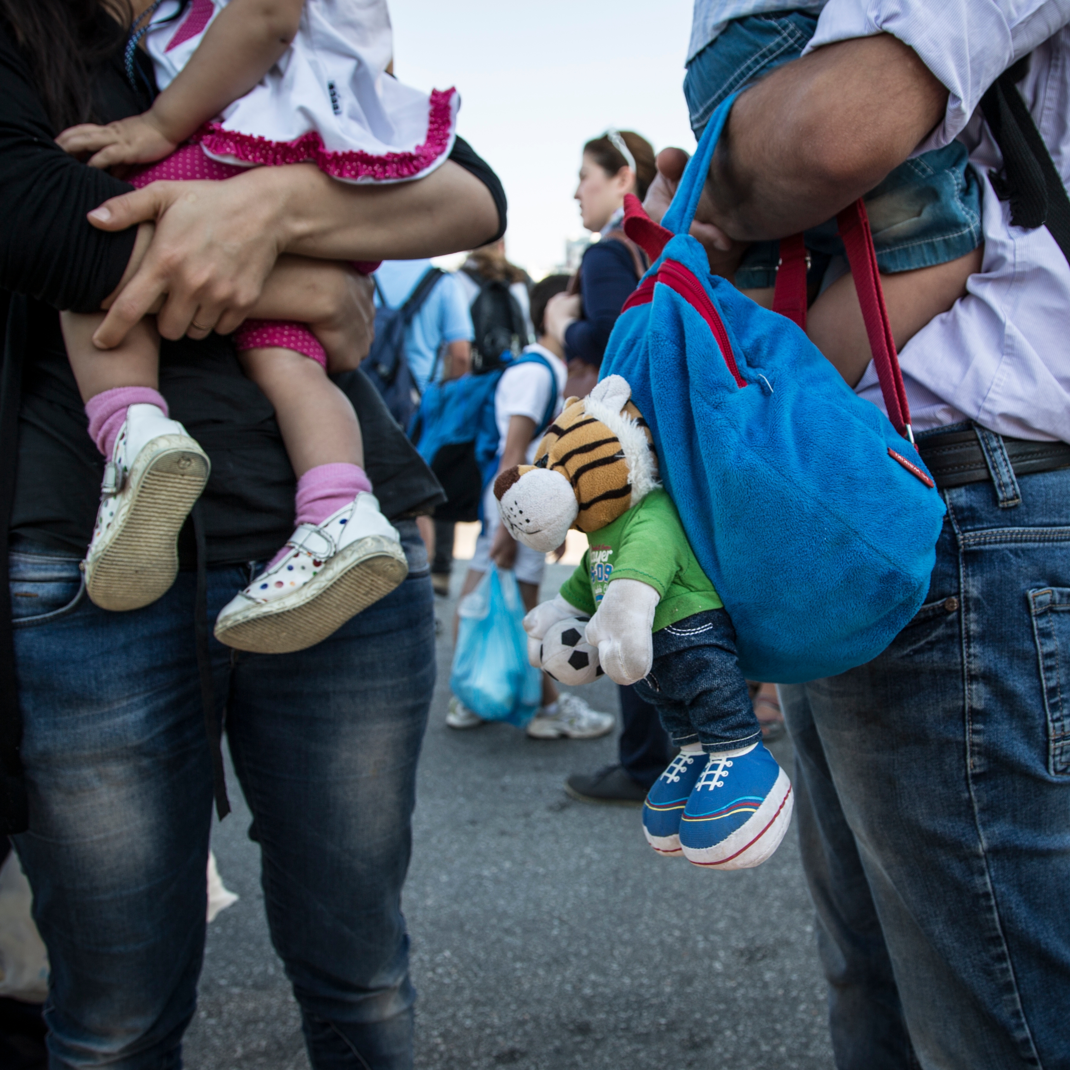 Syrian parents with their children in their arms in Athens, leaving the ferry they travelled on from Kos. "I don’t want to look to the right of me because there is Turkey. And I don’t want to look to the left because there is the island of Kos. The only place to look is ahead, straight to Athens," Farah said. Photo credit: Hedinn Halldorsson/Save the Children 2015.