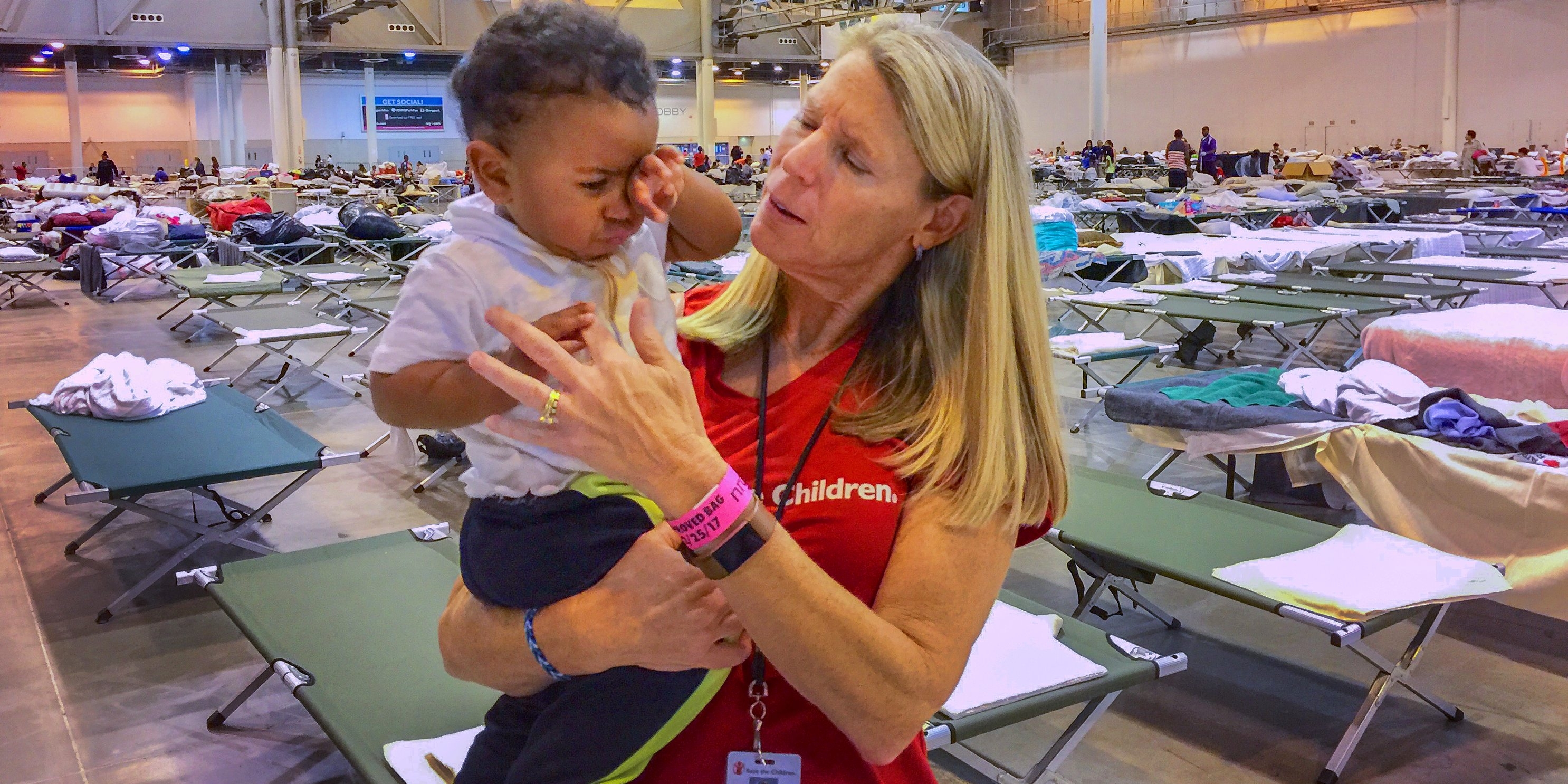 Carolyn Miles, president & CEO of Save the Children meets with families in a mega-shelter in Houston, Texas. Photo Credit Susan Warner/Save the Children 2017.