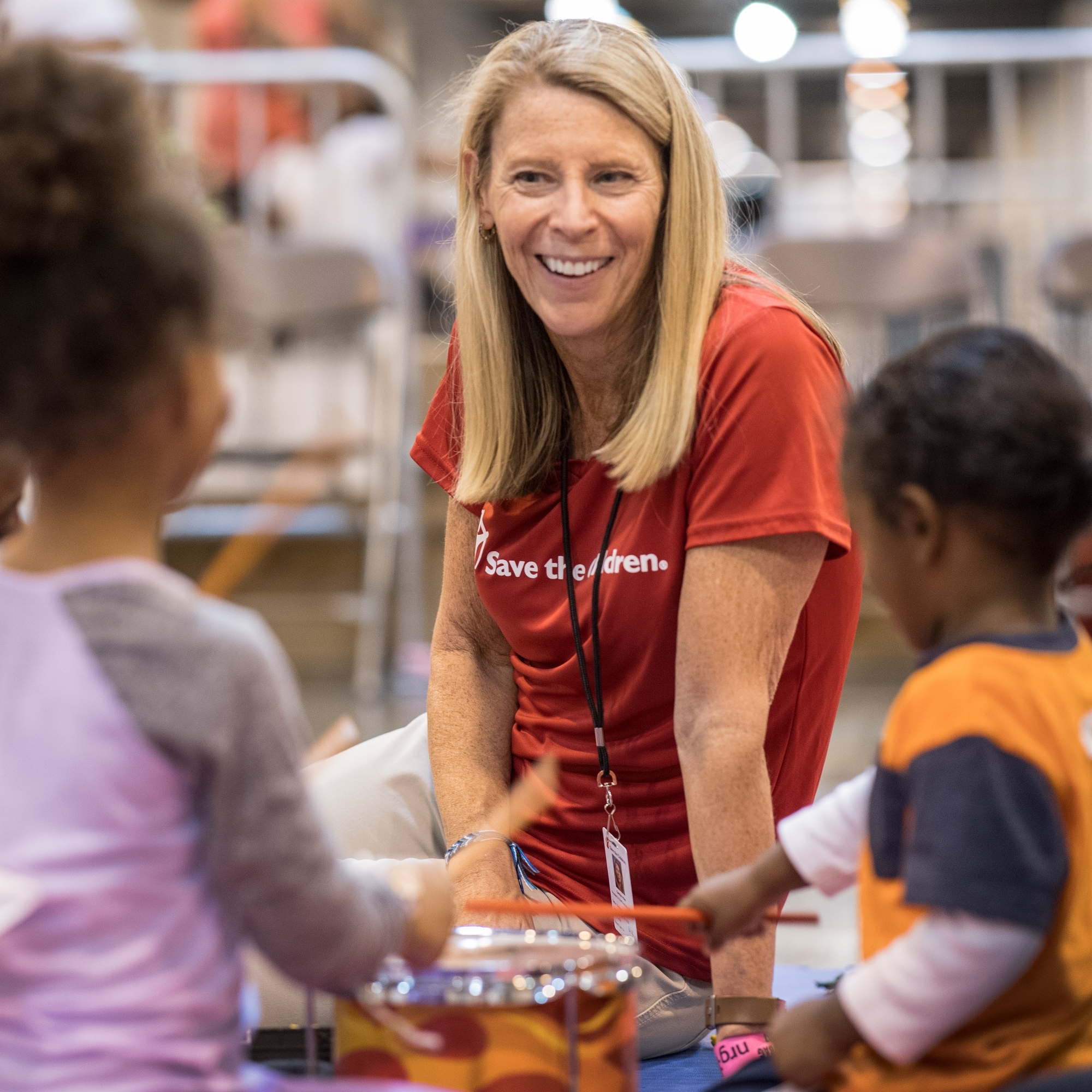 Carolyn Miles, president & CEO of Save the Children meets with children in a mega-shelter in Houston, Texas.  Photo Credit Susan Warner/Save the Children 2017.