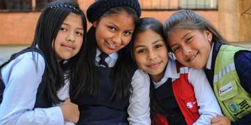 Monday September 28th, 2015 Cochabamba, Bolivia: Sponsod girl, 11-year-old Noelia ( red vest) with her friends, Brenda, 11 ( beads), Maria-Jose 12, ( hat) and Aracely, 12 ( green vest).They attend the (name of school) a school supported by Save the Children sponsorship programs.released