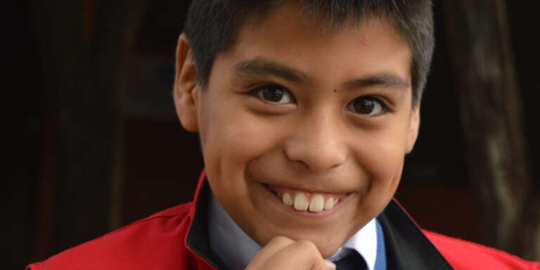 A young boy smiles.