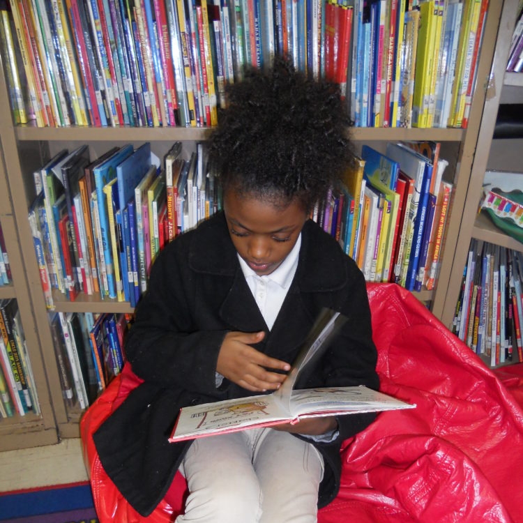 Dayla enjoying reading a story. Photo credit: Save the Children 2017.