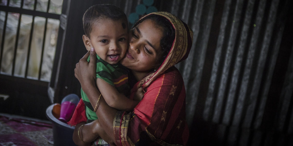 A young mother hugs her child in her home in Asia. In many contexts, the youngest mothers (ages 15-24) are less likely than older mothers to use health services, including postpartum family planning (PPFP), for themselves and their children, increasing their vulnerability to rapid repeat pregnancy</a> and poor health outcomes.