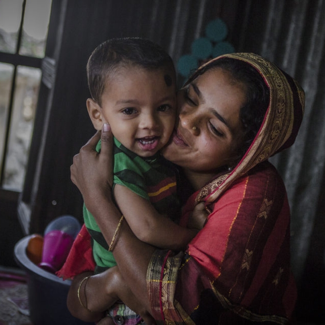 A young mother hugs her child in her home in Asia. In many contexts, the youngest mothers (ages 15-24) are less likely than older mothers to use health services, including postpartum family planning (PPFP), for themselves and their children, increasing their vulnerability to rapid repeat pregnancy</a> and poor health outcomes. Photo credit: CJ Clarke / Save the Children, 2015.
