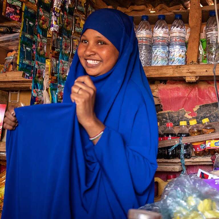A woman in her shop for displaced people in Somalia provided by a Save the Children grant.