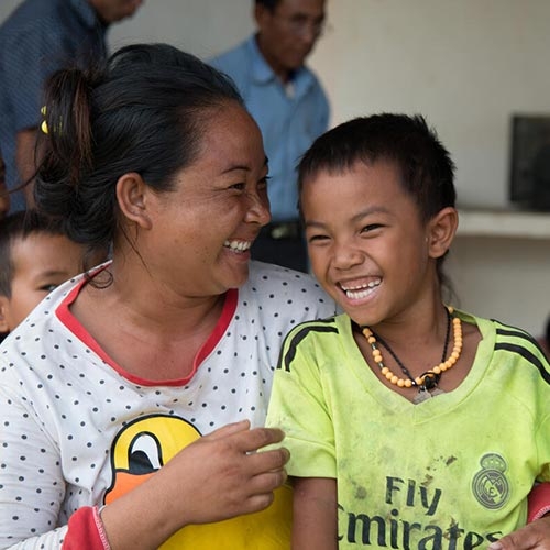 A woman and boy smile in Laos