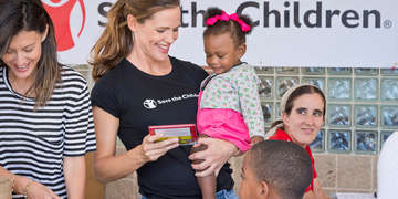 Jennifer Garner, Save the Children trustee and ambassador, holds a 1-year-old girl during a visit to Hilliard Elementary School in Houston, TX. The team surveyed the damage done by Hurricane Harvey and distributed childcare supplies and educational materials to locals. Photo credit: Anthony Rathbun/Save the children, September 2017, in Houston, TX.