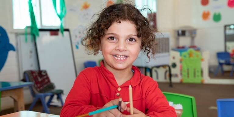 A young pre-school student in a Syrian refugee camp in Jordan