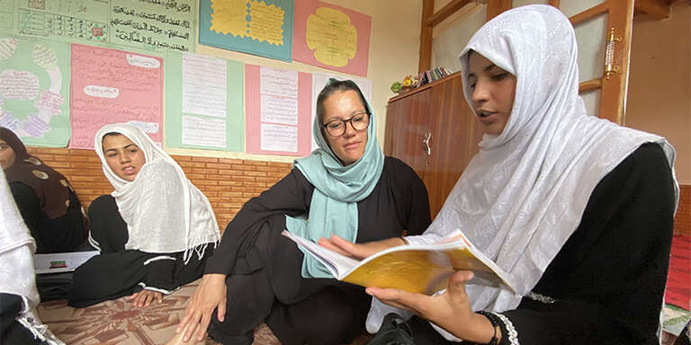 Save the Children CEO Inger Ashing talking to Farzana during her visit to a girls' class in Kabul, Afghanistan