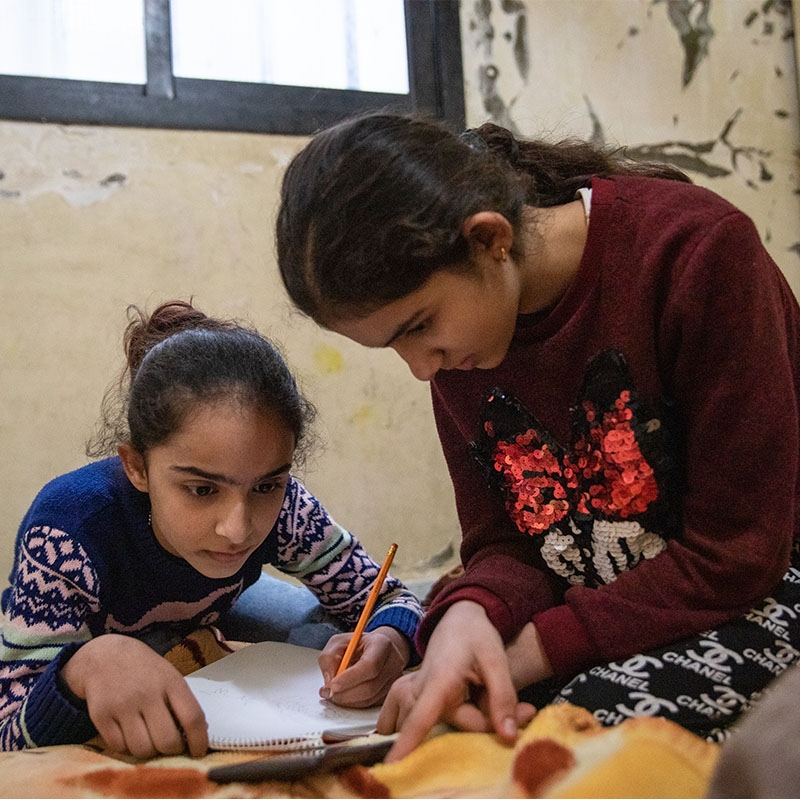 Syrian sisters living in Lebanon complete their homework