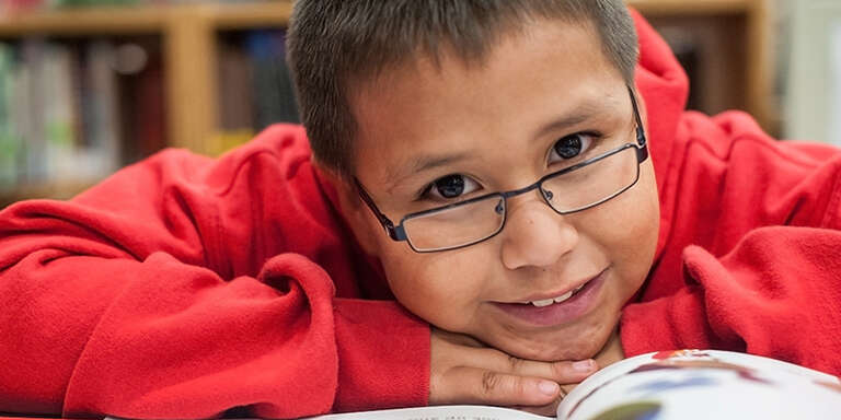 A boy reading a book. 