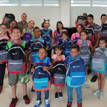 Children in Puerto Rico smile as they receive Comfort Kits assembled by Disney VoluntEARS in response to Hurricane Maria.  Photo Credit: Save the Children / June 2018 