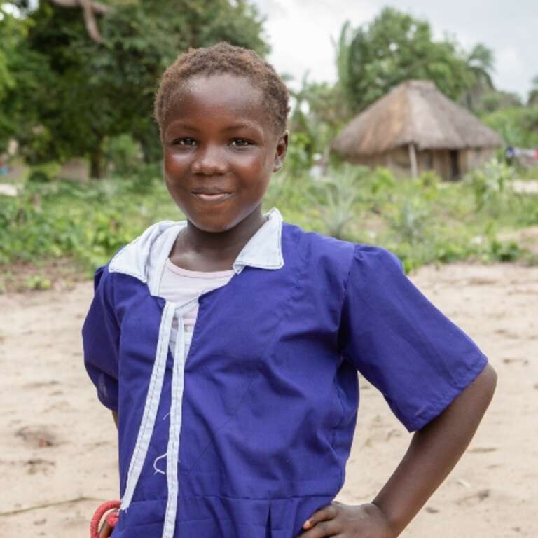 Tiageny in front of her school is Sierra Leone