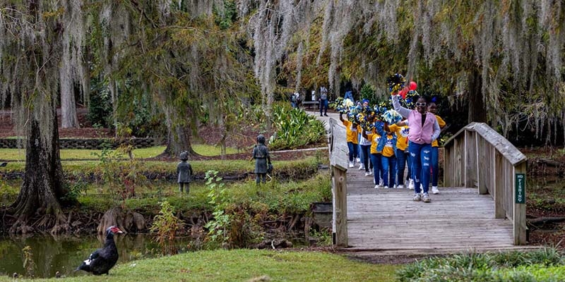 USA, a group of kids march in a park for a Bridge the Gap for Kids event.
