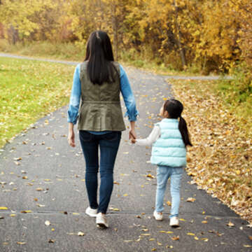 Rearview shot of a mother and daughter enjoying a walk outdoors. Photo credit: iStock/Save the Children, March 2020. 