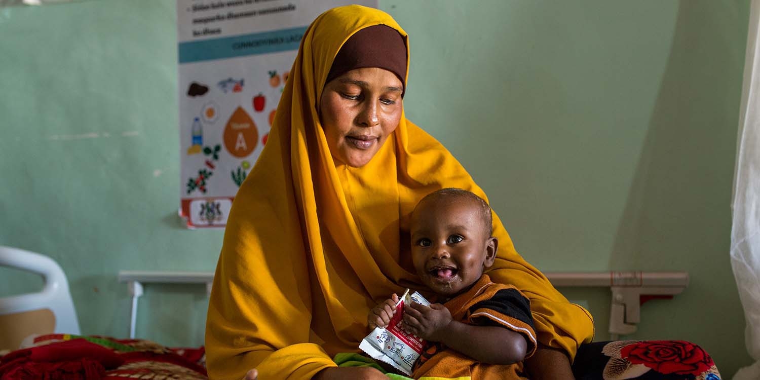 Somalia a 10-month-old baby is cradled by his mother after receiving therapeutic food