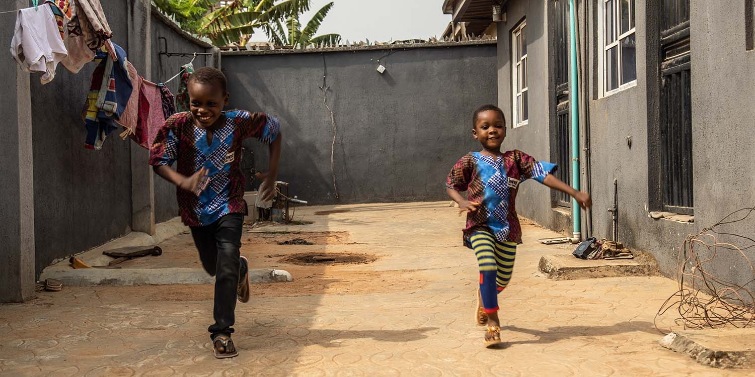 Nigeria, a young brother and sister run together