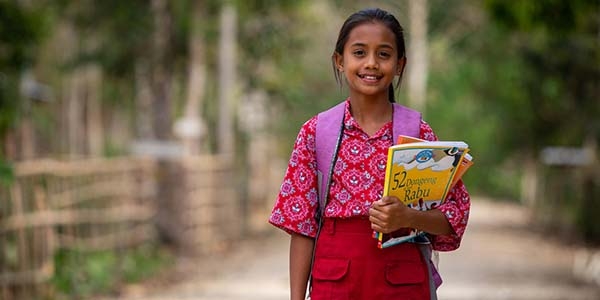 11-year-old Tiara walks home from school with storybooks from her schools library on Monday, August 5, 2019 in Sumba Island, Indonesia. In 2017, Tiara was given the opportunity to become a reading ambassador at her school. Through the ambassador program students are encouraged to become agents of change in their school to promote a culture of reading amongst their peers. “I felt happy and proud to be selected as a Reading Ambassador," Tiara said. “I want to be a teacher when I grow up so I can teach children like me to read.”