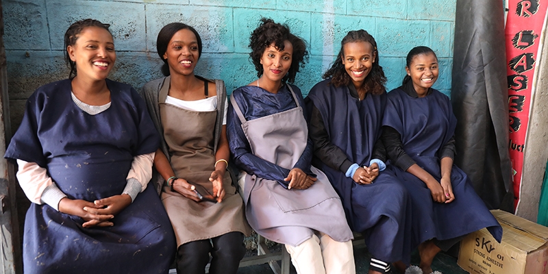 Ethiopia, women with the help of LEEP expanded their shoemaking business smile at the camera.