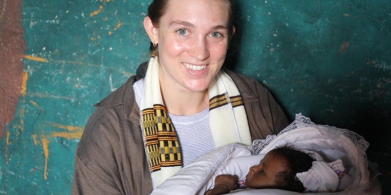 Ethiopia, a young women holds a baby.