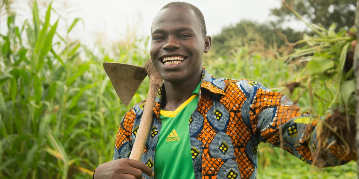 A Youth in Action program graduate student named Kassoum proudly stands in a field in Burkina Faso that is brimming with large, green crops. As the sun shines, Kassoum holds a large harvesting tool over his shoulder and smiles as he displays the freshly picked vegetables his year-round small farm produces. In partnership with Mastercard Foundation, Save the Children’s Youth in Action program works to improve the socio-economic status of over 40,000 out-of-school youth, girls and boys, aged 12-18 in rural Burkina Faso, Egypt, Ethiopia, Malawi and Uganda. Photo credit: Harrison Thane | Save the Children, August, 2017.