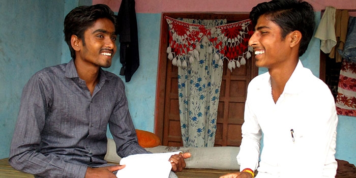 Shivdas and a friend talk while studying for high school classes.