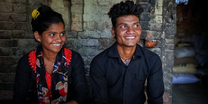 16-year-old Sonu, left, sits beside her 19-year-old brother Ganesh inside of her family home on within the Kapilvastu region of Nepal. 