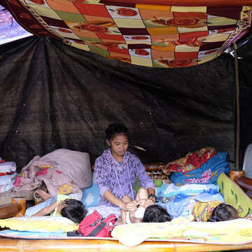 A girl attends to her siblings at an evacuation center in Davao del Sur, Philippines on October 31, 2019. Around 200 families are said to have evacuated here after their homes were either damaged or destroyed by the magnitude 6.6 earthquake that hit the neighboring province on October 29, 2019. A fifth earthquake has struck the same region on December 15, putting children's lives at risk once again. Photo credit: LJ Pasion/Save the Children, Oct 2019.