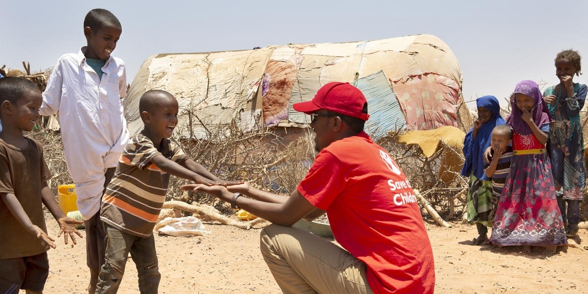 A Save the Children staff member visits children in a village in Somalia where drought has devastated crops and forced many families to be displaced. More than 1.5 million people have become internally displaced in Somalia since November 2016 as a result of drought, conflict and flooding. Photo credit: Marieke van der Velden / Save the Children, April 2019.