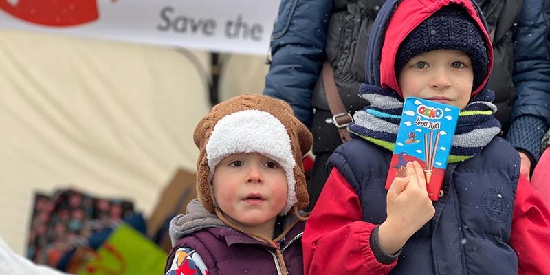 Two refugee children who have fled conflict in Ukraine receive emergency supplies after crossing the border.