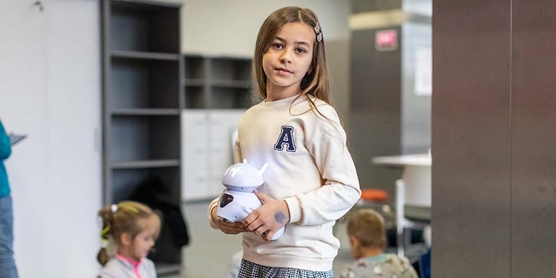 A 9-year old girl stands in a digital lerning center in Poland design to support Ukraine refugee children. 
